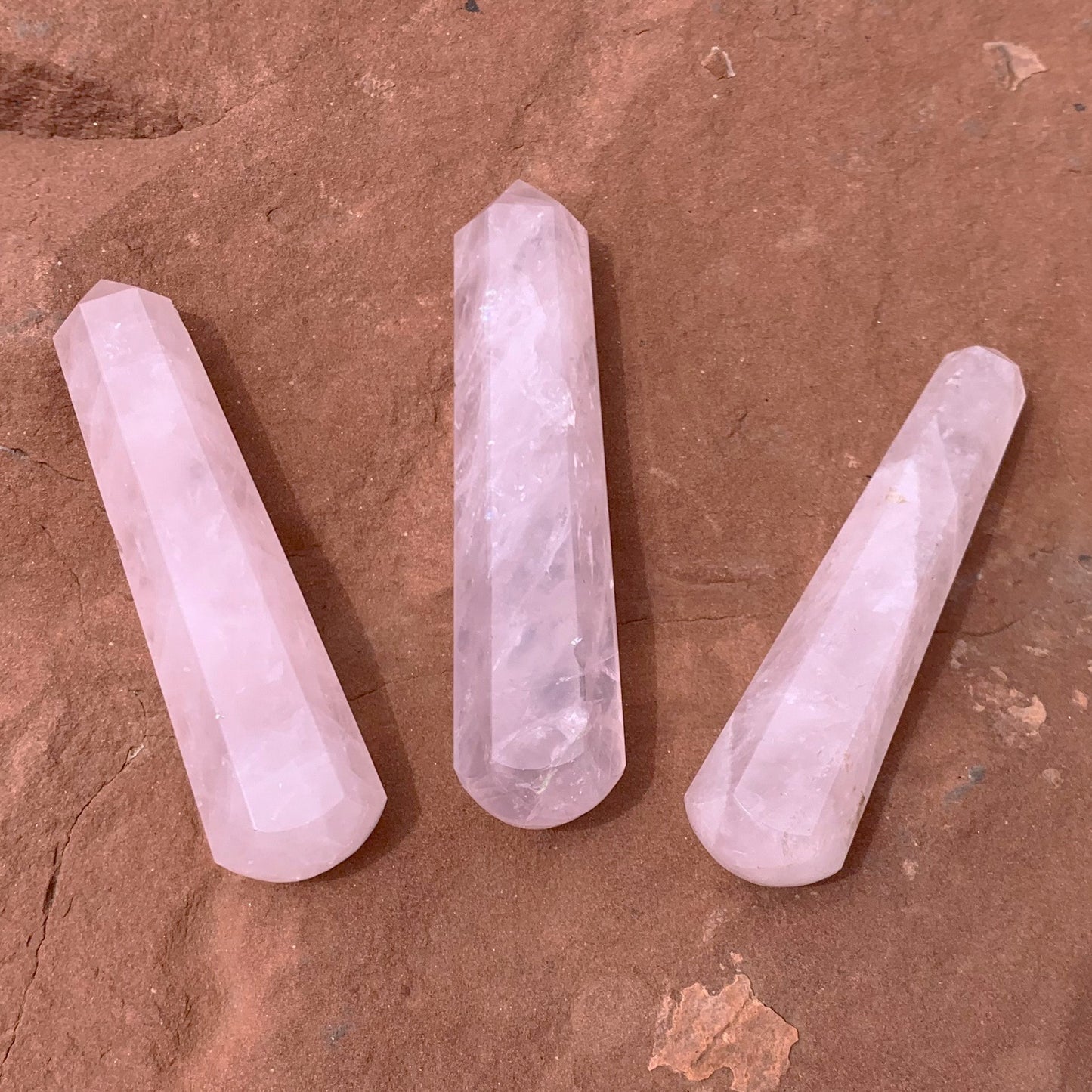 Rose Quartz points on natural red rock surface