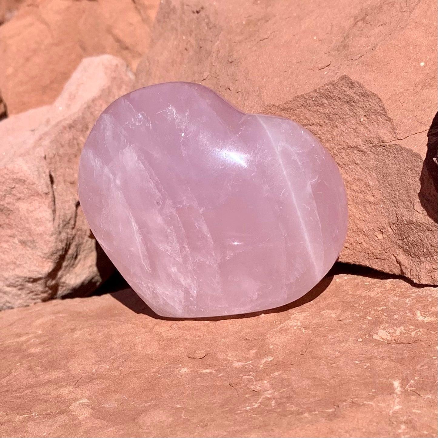 Rose Quartz heart crystal held for love energy