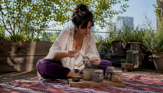 Woman preparing herbal calming tea at home