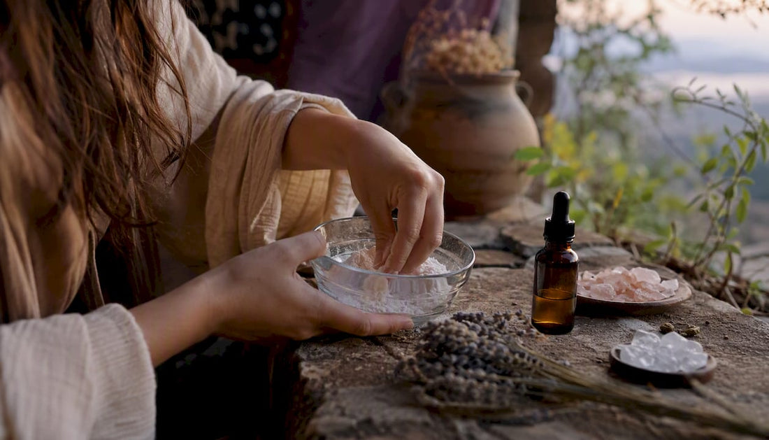 Hands stirring white powder in a glass bowl