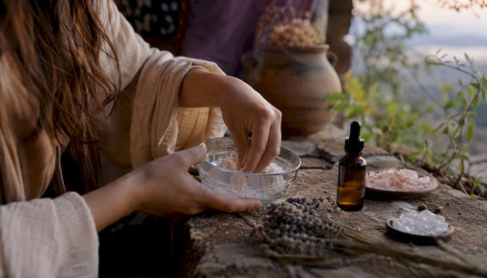 Hands stirring white powder in a glass bowl