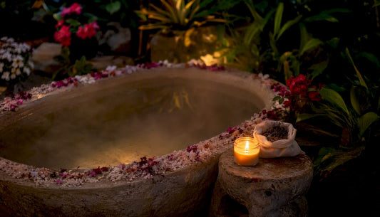 Bath edge with salts, lavender bag, and candlelight